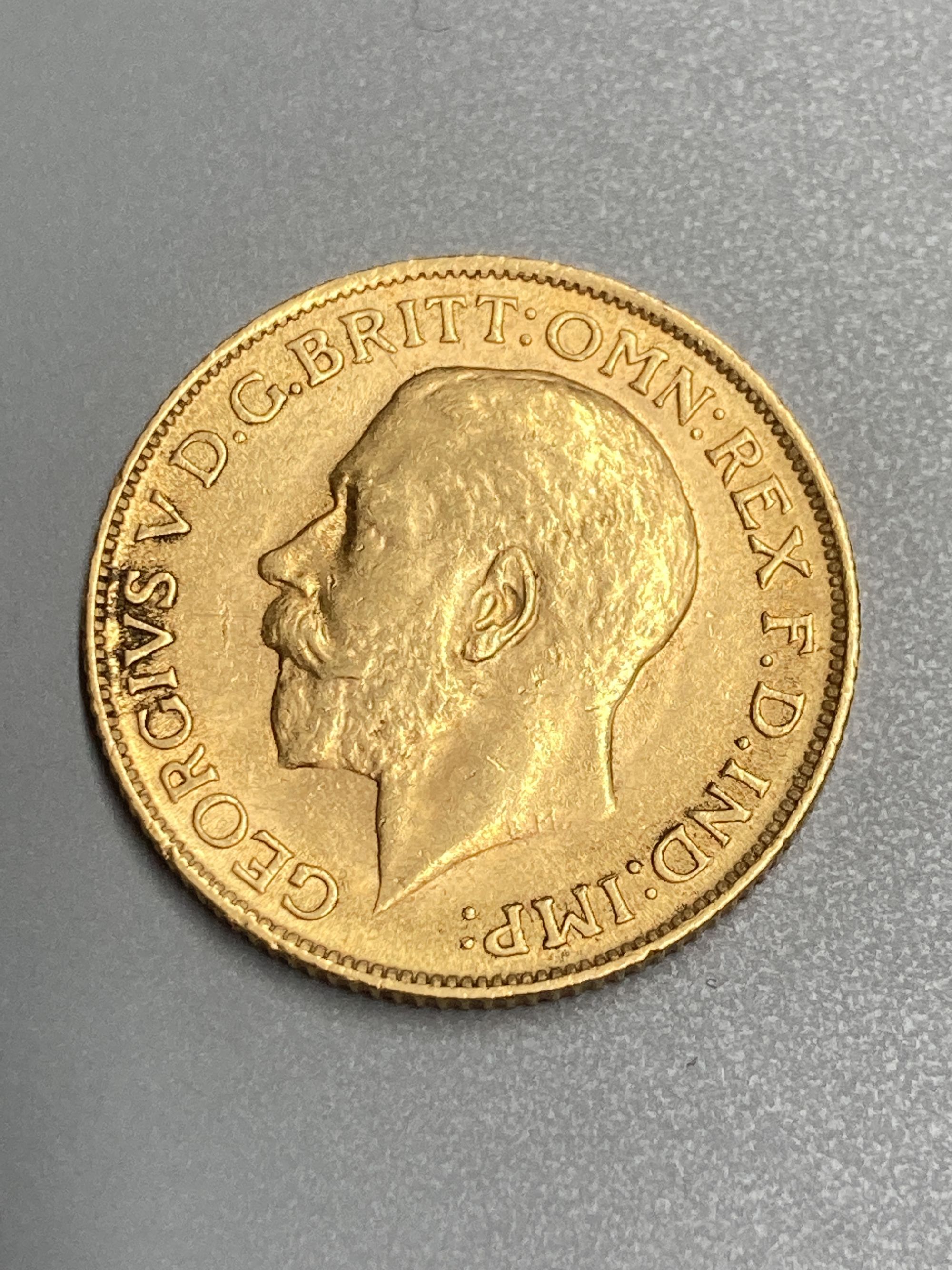 A George V 1911 gold sovereign, GVF.